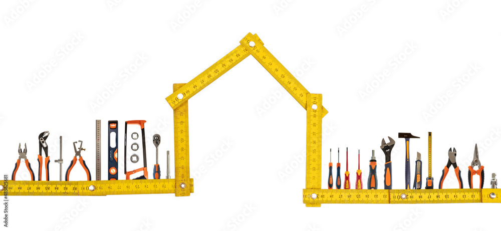 DIY and home maintenance. Work tool set and house shape wooden measure isolated on white